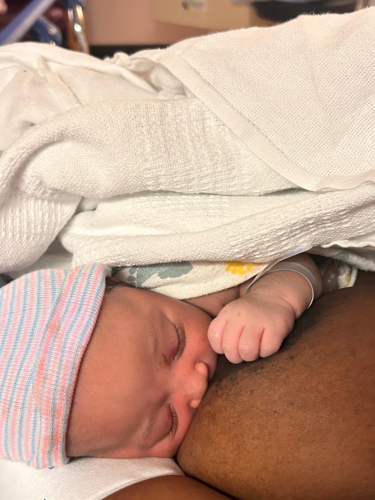 A newborn resting skin-to-skin on their mother shortly after birth